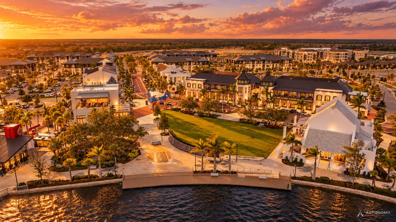 Aerial view of Downtown Wellen and its lakefront lawn on the Grand Lake at sunset, Wellen Park, Venice FL